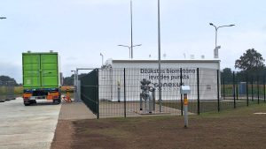 Latvijā pirmais publiskais biometāna ievades punkts Džūkstē ar zaļu kravas konteineru blakus.
