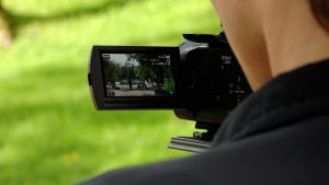 Videokamera filmē dabu un cilvēkus pie ezera