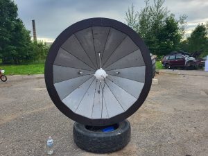 Liels paštaisīts metāla šķīvis uz riepas industriālā vidē
