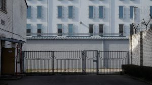 Cietuma ēkas fasāde ar žogu