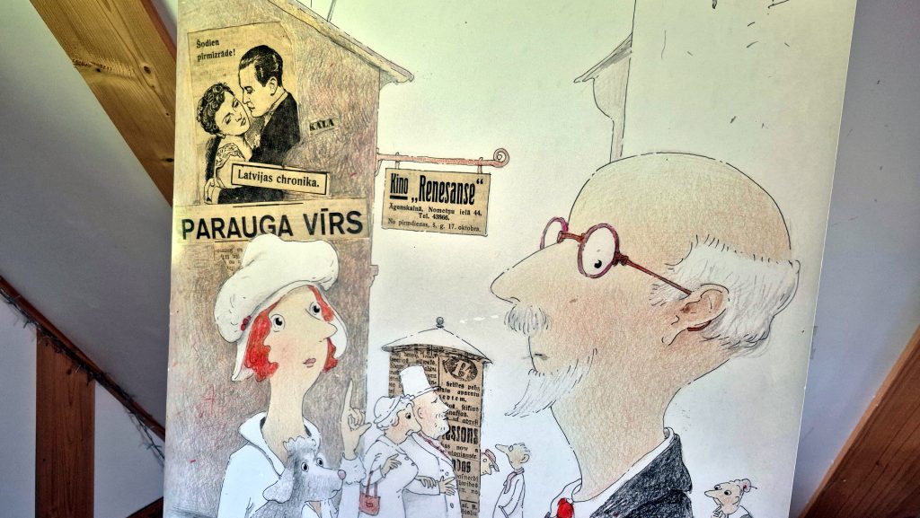 Ilustrācija, kurā attēlots Rainis un citi cilvēki pilsētas ainavā.