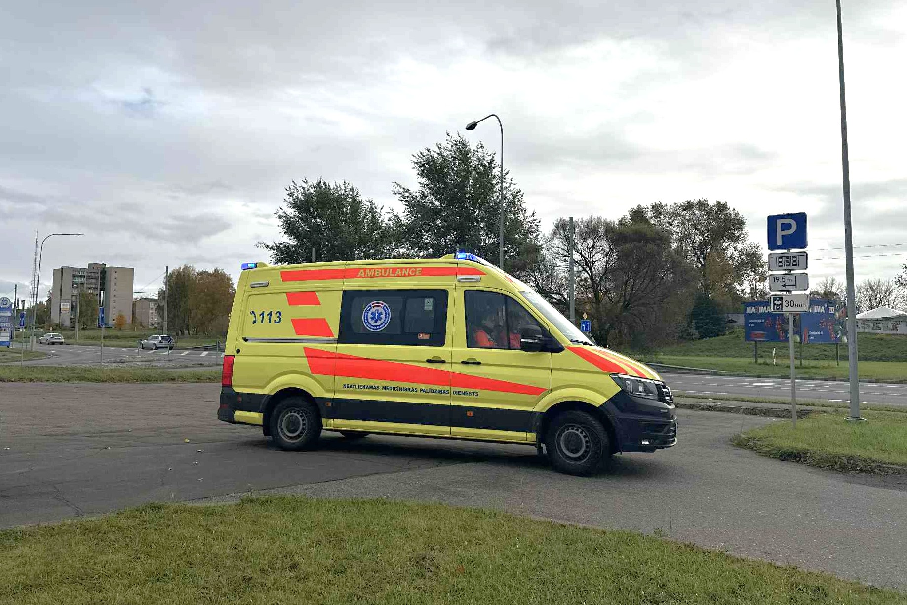 NMPD ātrās palīdzības automašīna ar ieslēgtām zilām bākugunīm izbrauc no stāvvietas Daugavpilī.