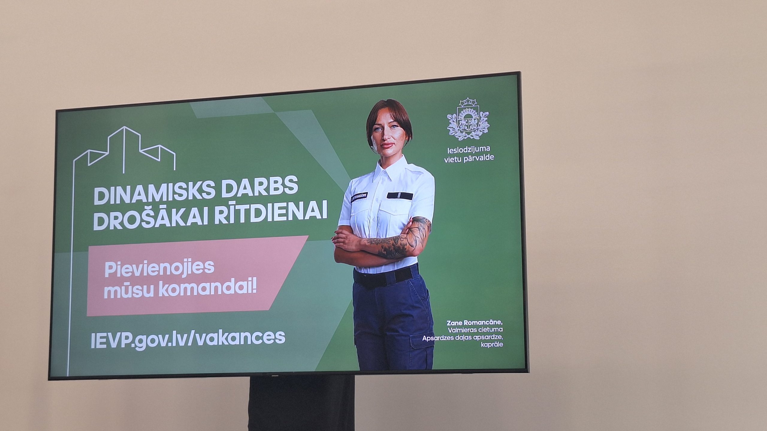 Kampaņas “Dinamisks darbs drošākai rītdienai” plakāts ar Ieslodzījumu vietu pārvaldes darbinieci formā.