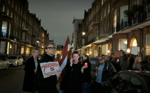 Protesta dalībnieki Londonā pie Latvijas vēstniecības ar plakātiem un Latvijas karogu, paužot atbalstu Stambulas konvencijai.
