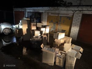 Valsts policijas atsavinātās kartona kastes ar nelegālajām cigaretēm, kas izņemtas kratīšanā pie garāžām.