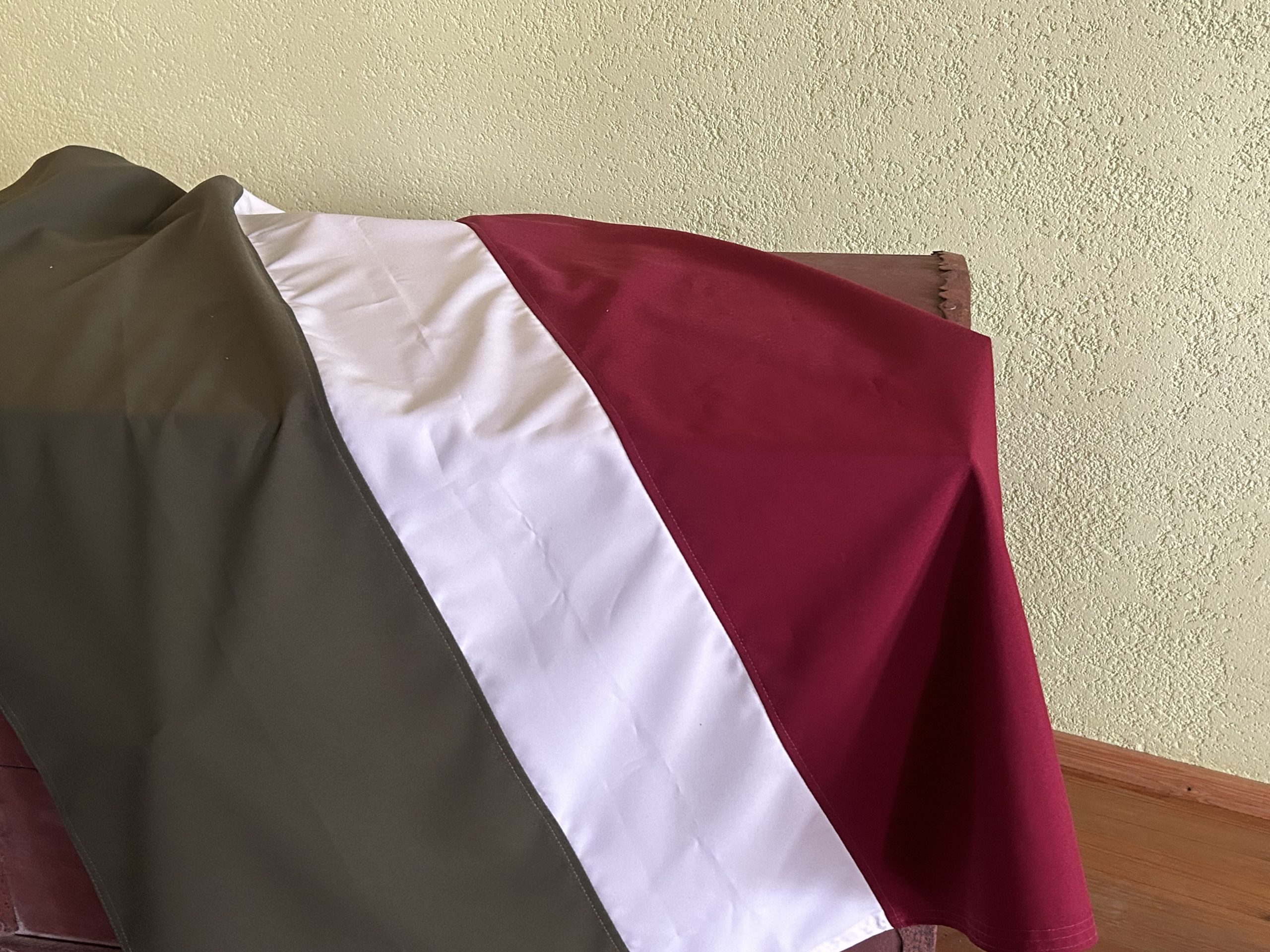 Sēlijas karogs ar sarkanbaltsarkanu un pelēku krāsu gammu telpā