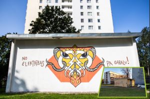 Grafiti ar stilizētu dzīvnieka motīvu un uzrakstu “No elektrības pa gabalu!” uz ēkas sienas.
