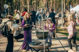 Bērni Lieldienu pasākumā Saulkrastos cep desiņas pie ugunskura