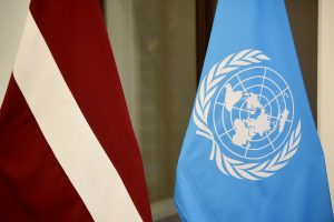 Latvijas un Apvienoto Nāciju Organizācijas karogi blakus telpā